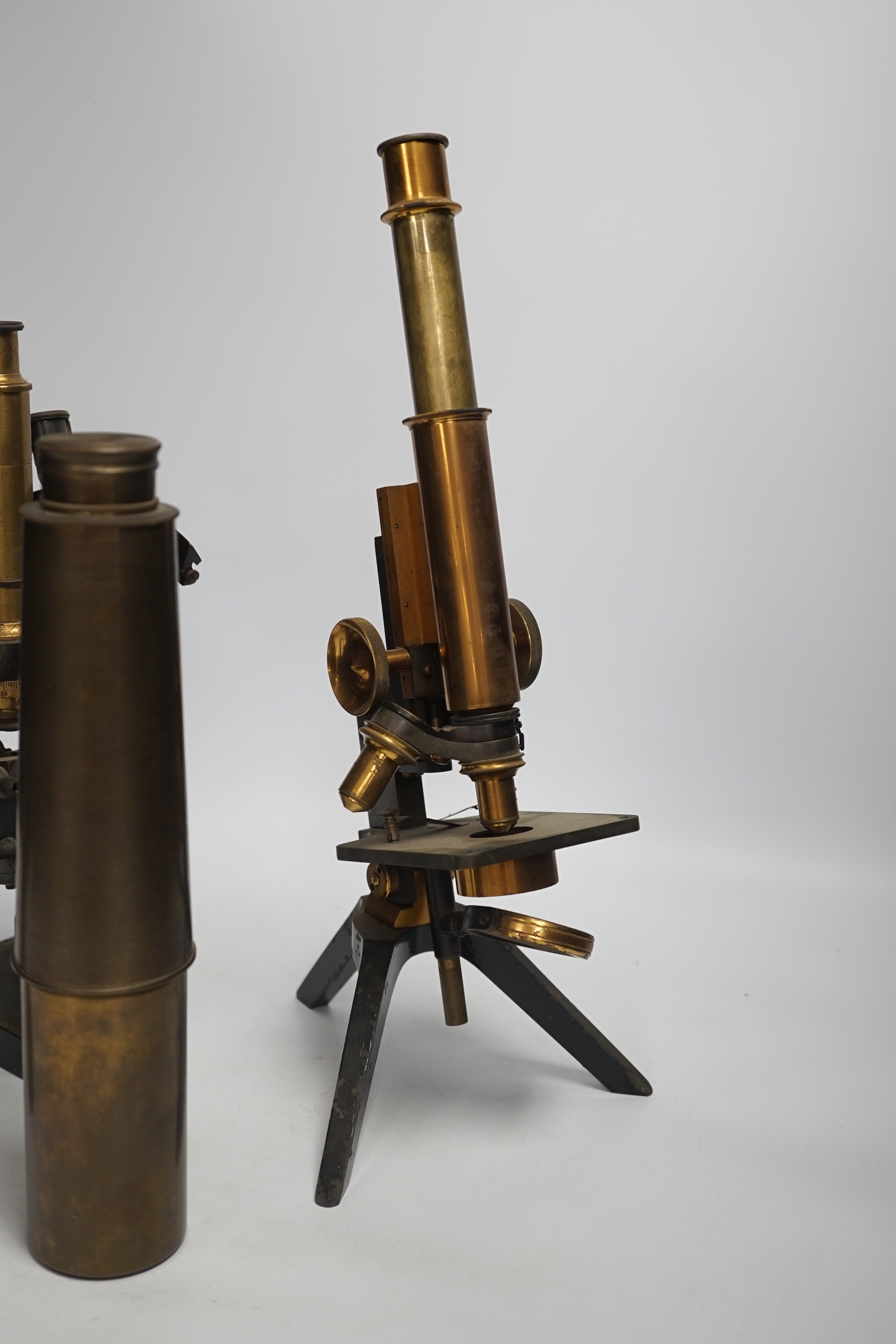 Two brass and black lacquered microscopes, one by Adam Hilger and two brass telescopes